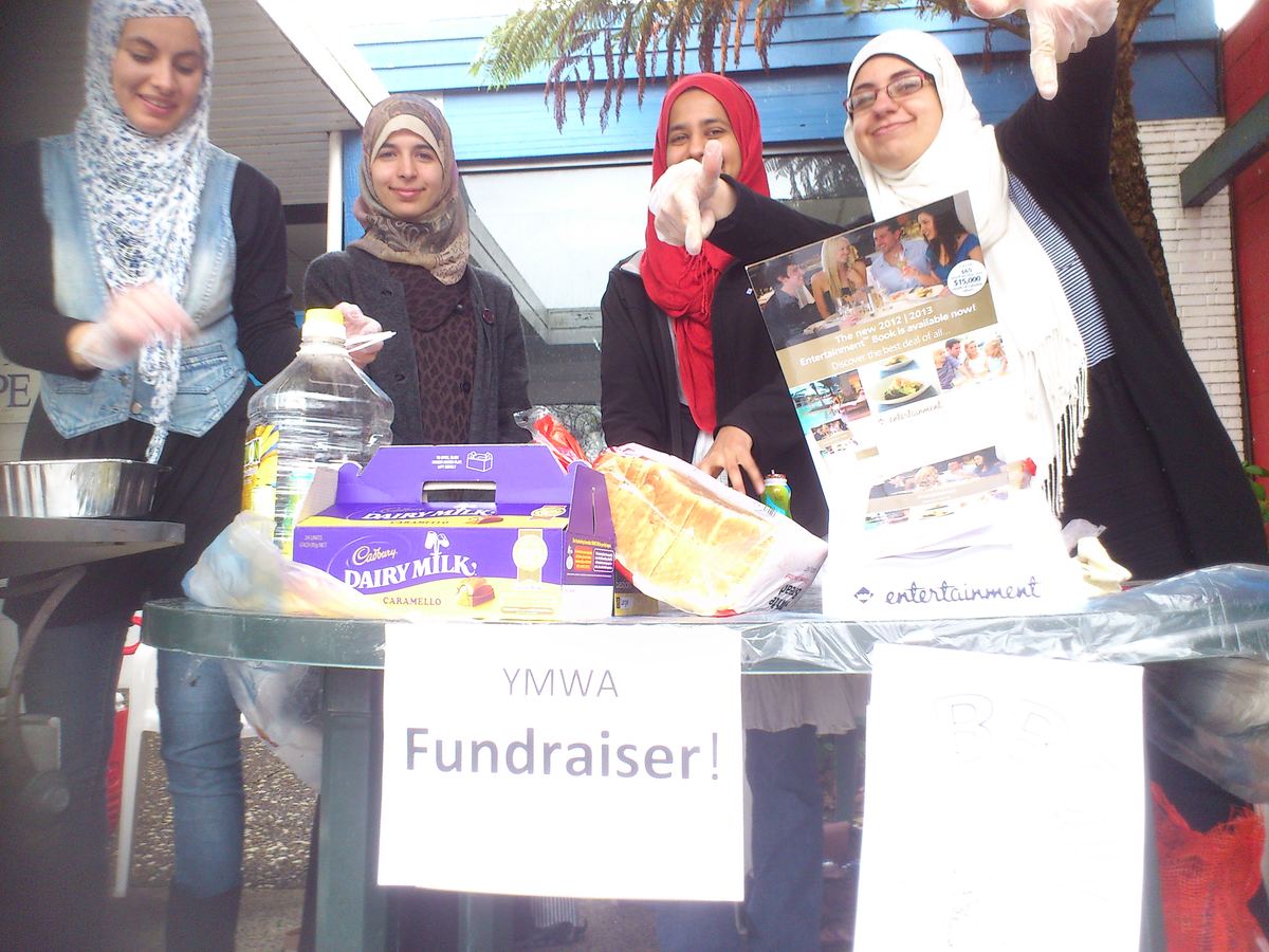 Members running a YMWA fundraiser stall